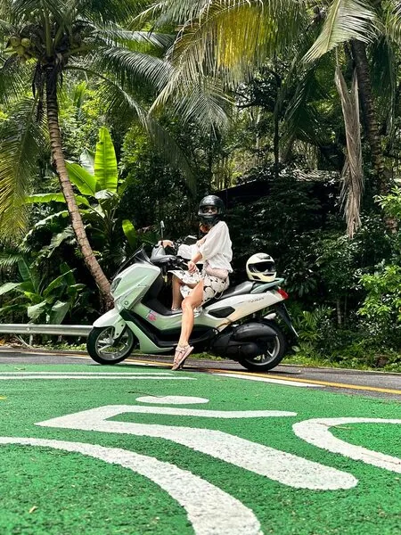 Student riding a scooter after getting a Thai licence